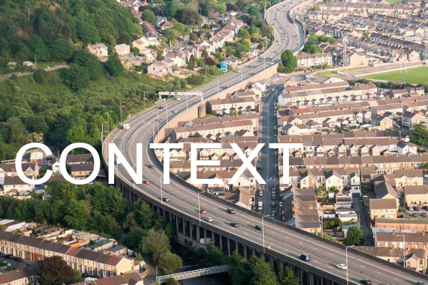 aerial photo of elevated motorway snaking through a community of houses